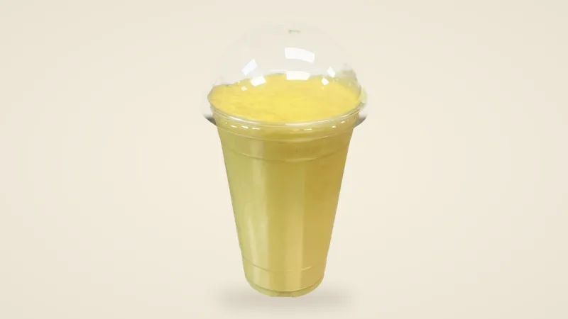 Golden Mango Velvet smoothie in a clear cup with a dome lid, side view