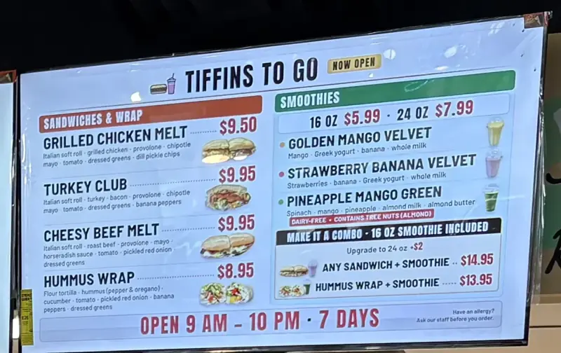 Tiffins ToGo TV menu showing four sandwiches, three smoothies, combo prices and hours of 9 AM to 10 PM, 7 days