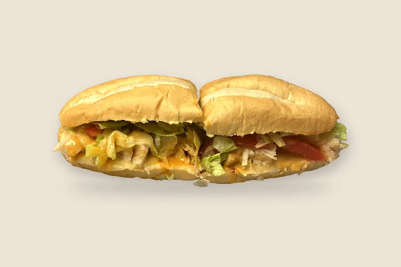 Grilled Chicken Melt on a toasted Italian soft roll, cut in half, with grilled chicken, melted provolone, tomato and greens